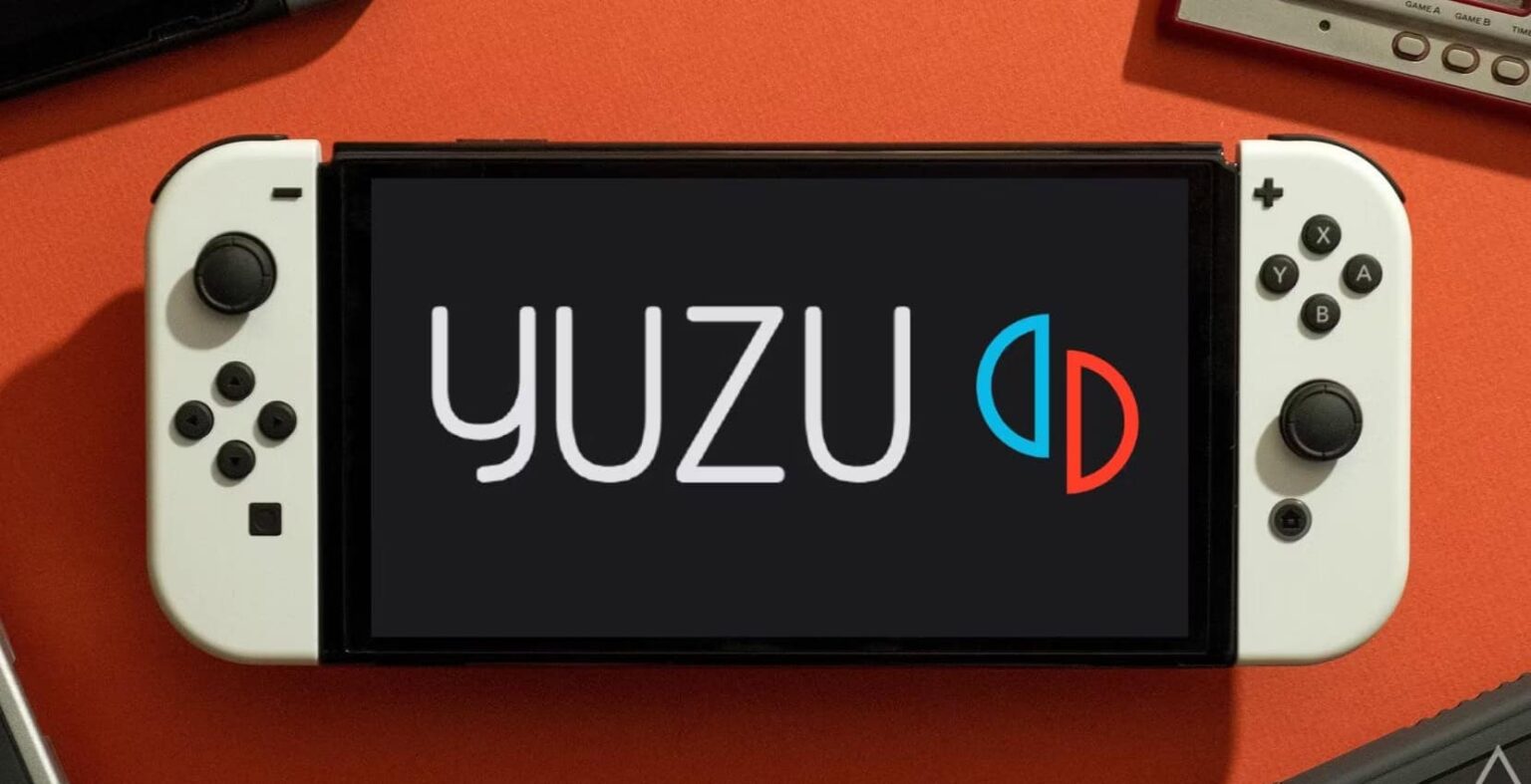 Console Nintendo Switch OLED com a tela exibindo o logo do emulador Yuzu sobre fundo laranja
