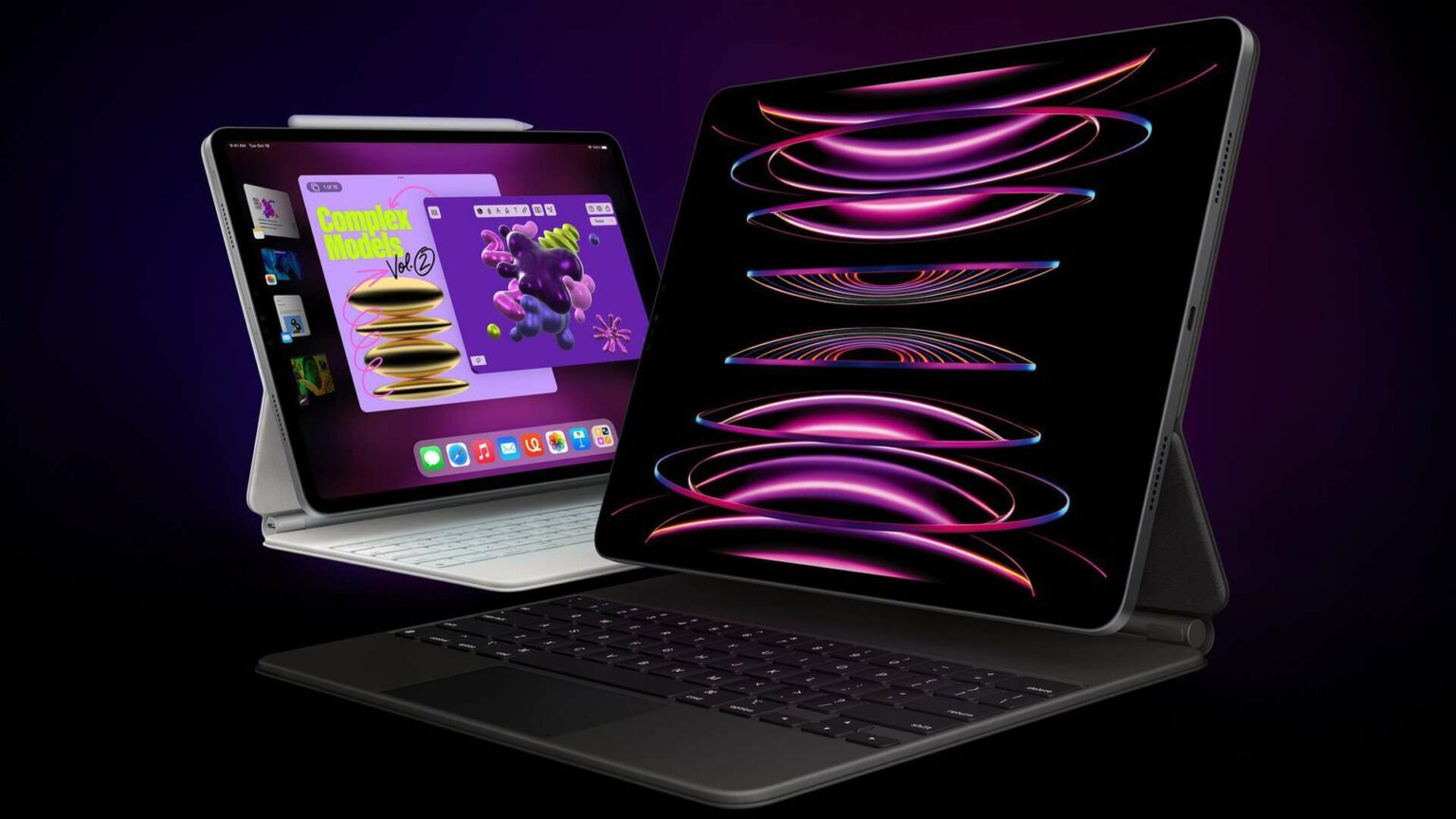 Dois iPads Pro lado a lado com teclado Magic Keyboard, exibindo arte abstrata roxa e rosa sobre fundo escuro