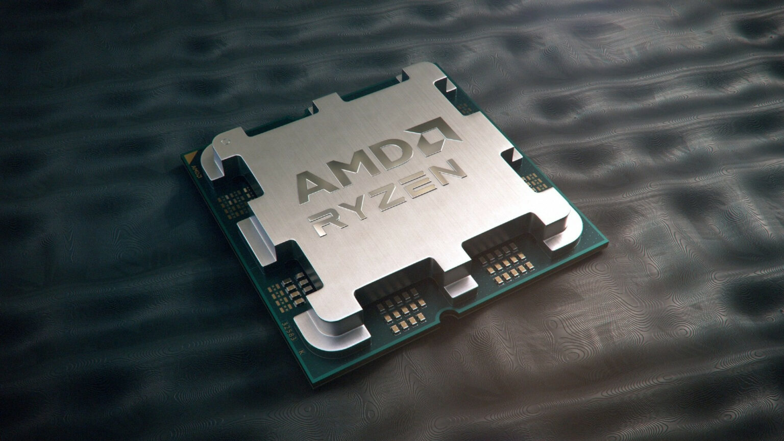 Processador AMD Ryzen com tampa metálica prateada e logotipo da marca, apoiado sobre superfície escura e texturizada