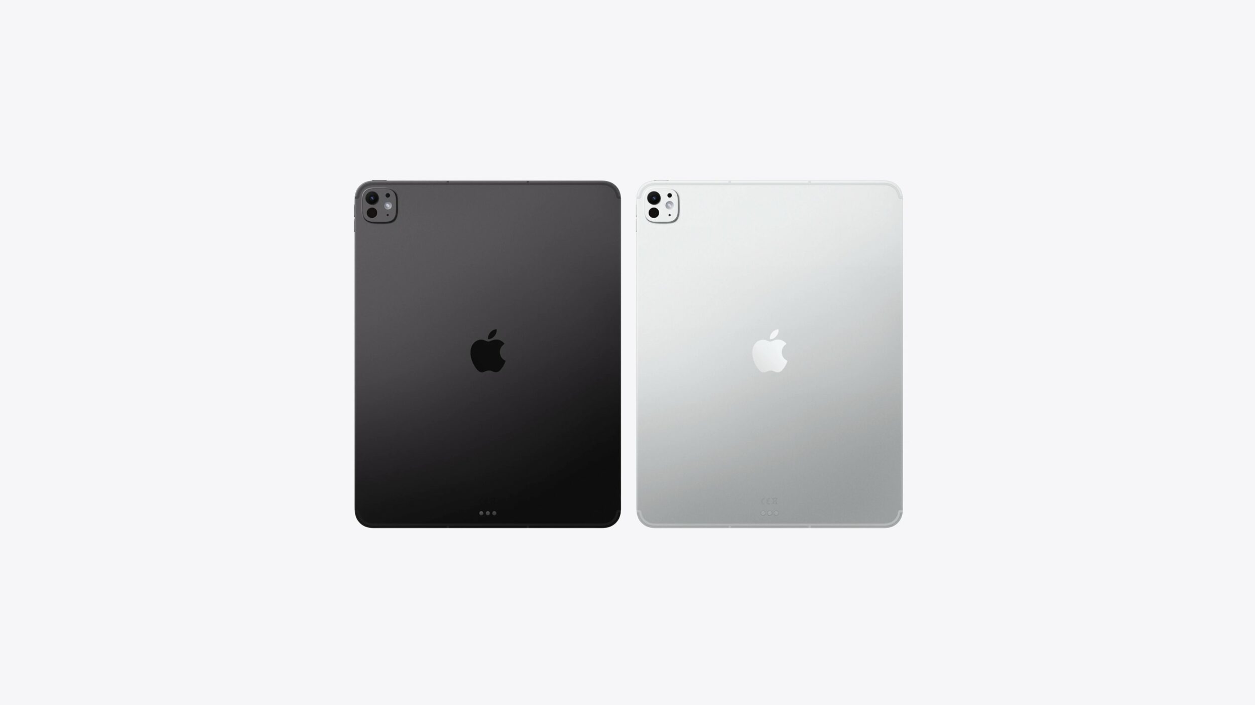 Dois iPads Pro da Apple, um na cor cinza-espacial e outro prateado, vistos de trás com câmeras e logo da maçã