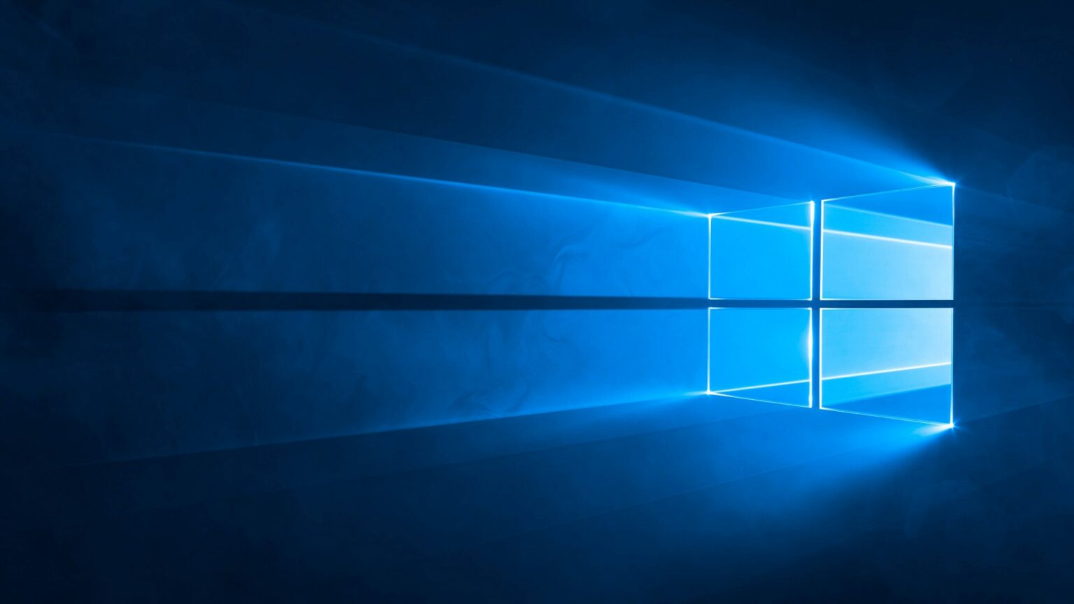 Logotipo do Windows formado por janelas azuis brilhantes em fundo escuro, com luz emanando das bordas, em destaque no tema do Windows 10