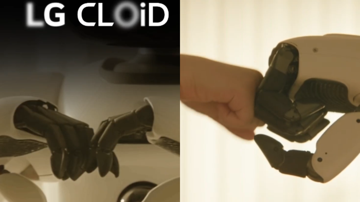 Mão robótica preta e mão robótica clara estendendo-se para punho humano destacando a cooperação homem-máquina no LG CLOiD