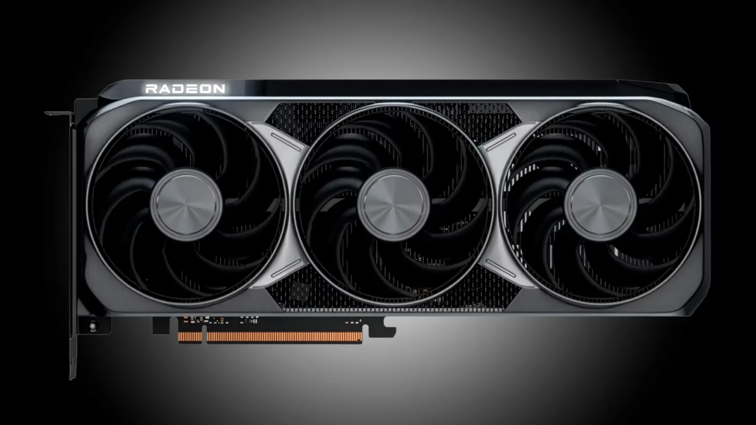 Placa de vídeo AMD Radeon com três ventoinhas e carcaça preta e prateada, em fundo escuro com iluminação de destaque