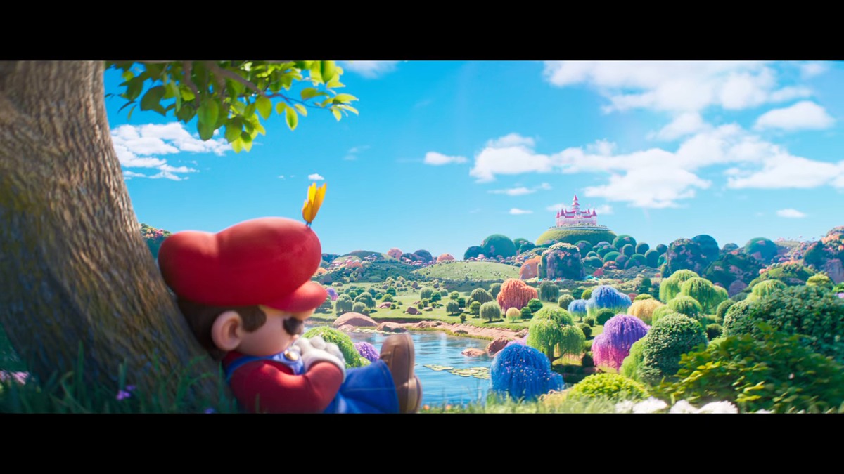 Mario apoiado em árvore em cena colorida de fantasia CGI de Super Mario Galaxy