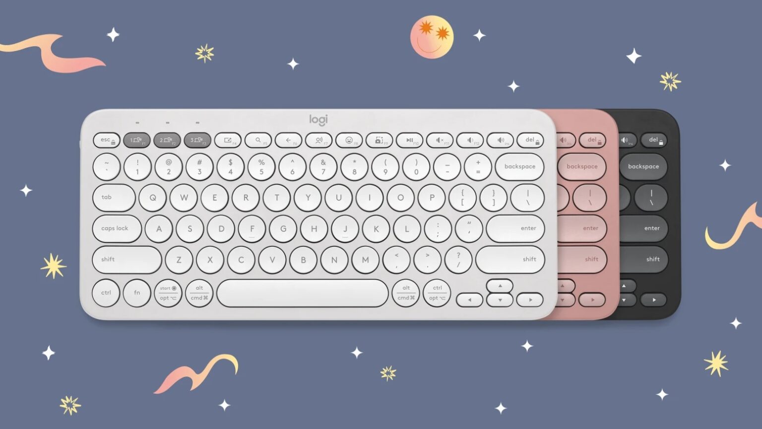 Três teclados sem fio Logitech Pebble Keys 2 nas cores branca, rosa e grafite, lado a lado, sobre fundo azul com estrelas e detalhes decorativos