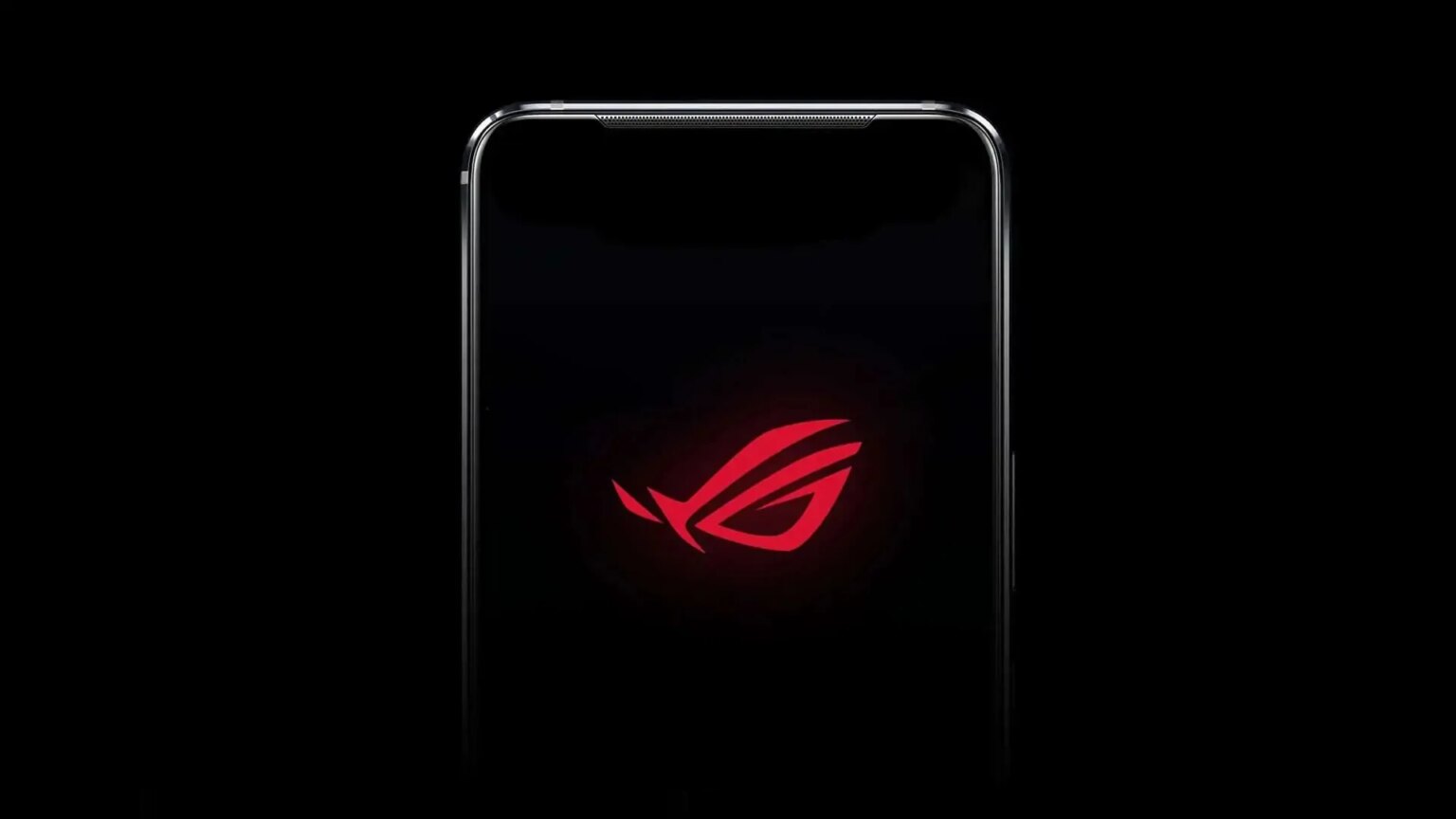 Smartphone gamer com tela preta e logotipo vermelho da linha ROG da Asus aceso no centro, em fundo escuro