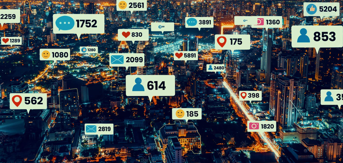 Vista aérea de cidade à noite com balões de notificações sobre os prédios, como curtidas, comentários, mensagens e localização, com contadores de números