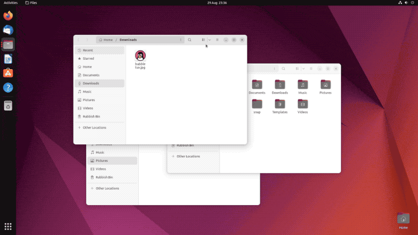 Captura de tela do Ubuntu 22.10 com o gerenciador de arquivos Files aberto na pasta Downloads e outra janela de arquivos sobreposta na área de trabalho