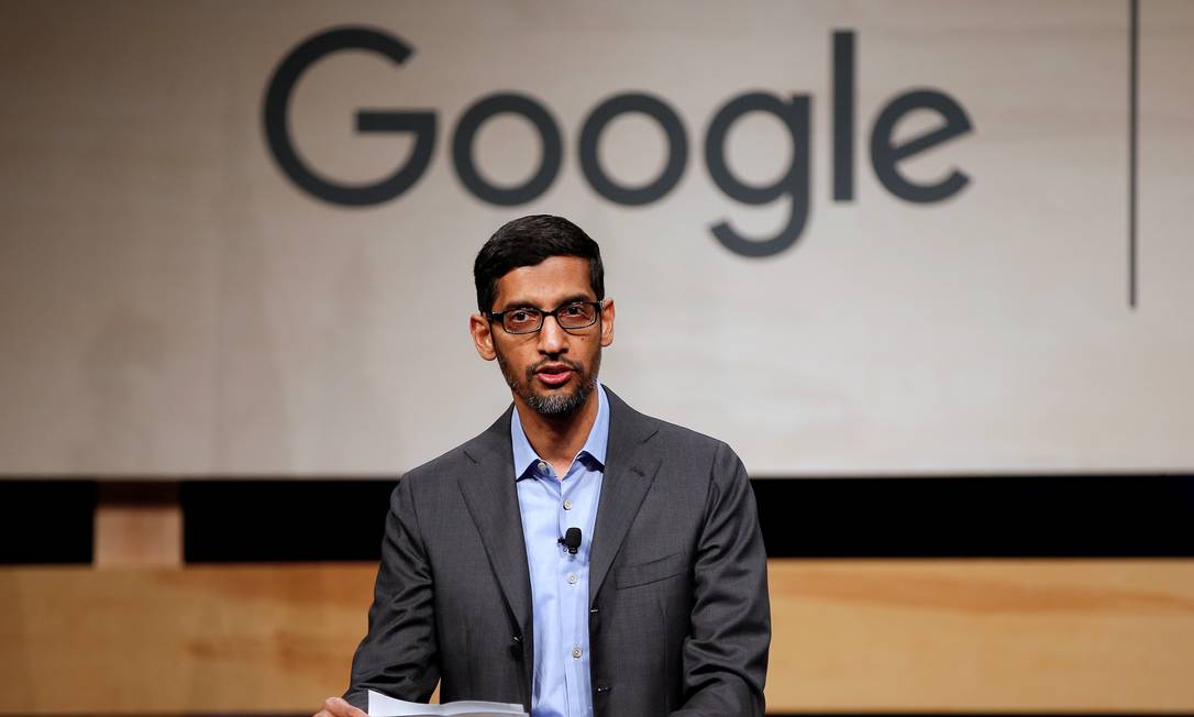 Sundar Pichai, CEO do Google, fala ao microfone em palco diante de um painel com o logotipo do Google