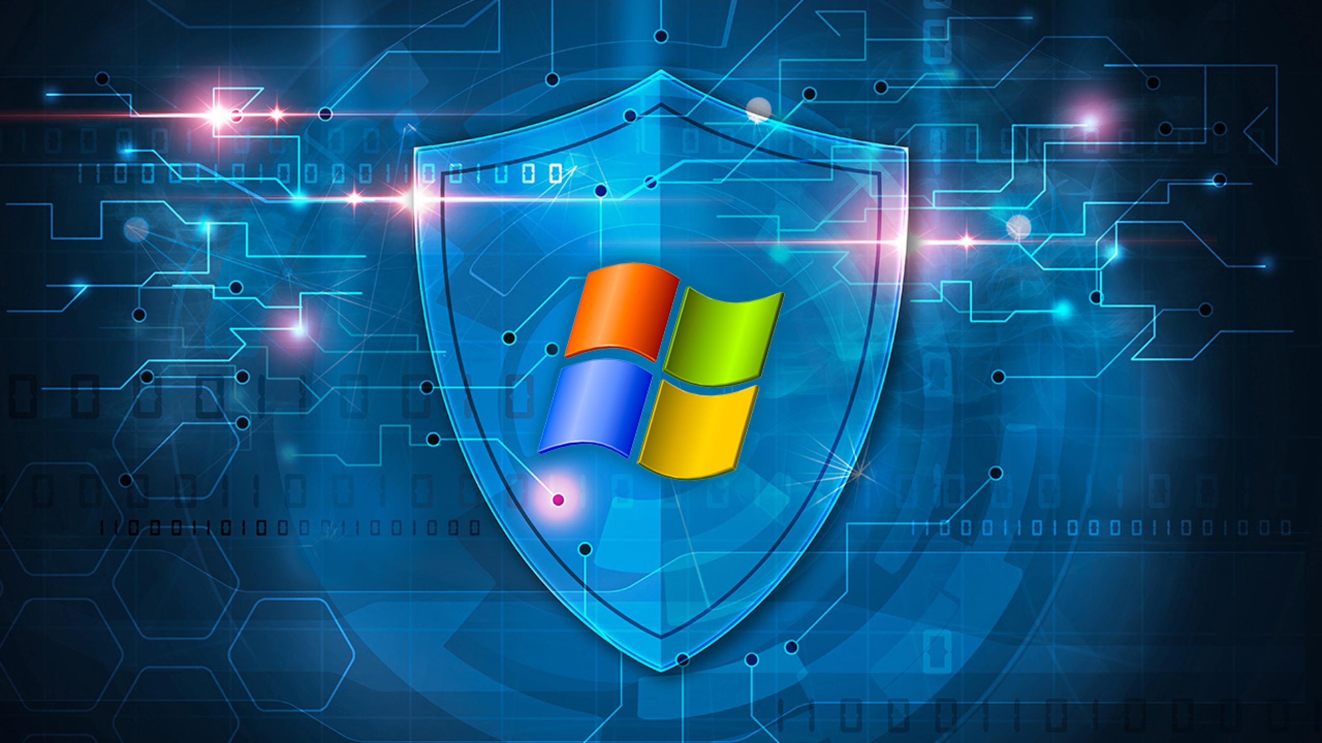 Escudo azul de segurança digital com o logotipo do Windows em destaque sobre um fundo tecnológico com circuitos e código binário
